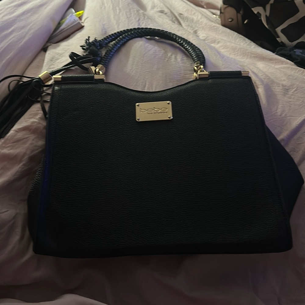 BEBE black purse has some damage on strap brand new